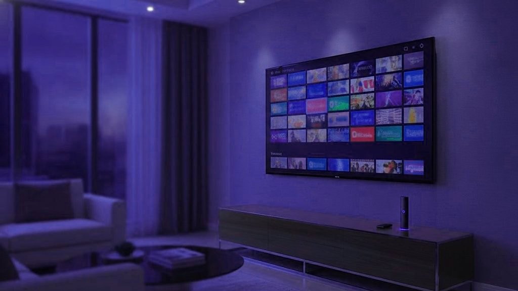 Cover for “What is IPTV? How television moved from the antenna to the internet”: a living room at dusk with a wall television showing rows of channel tiles above a low console